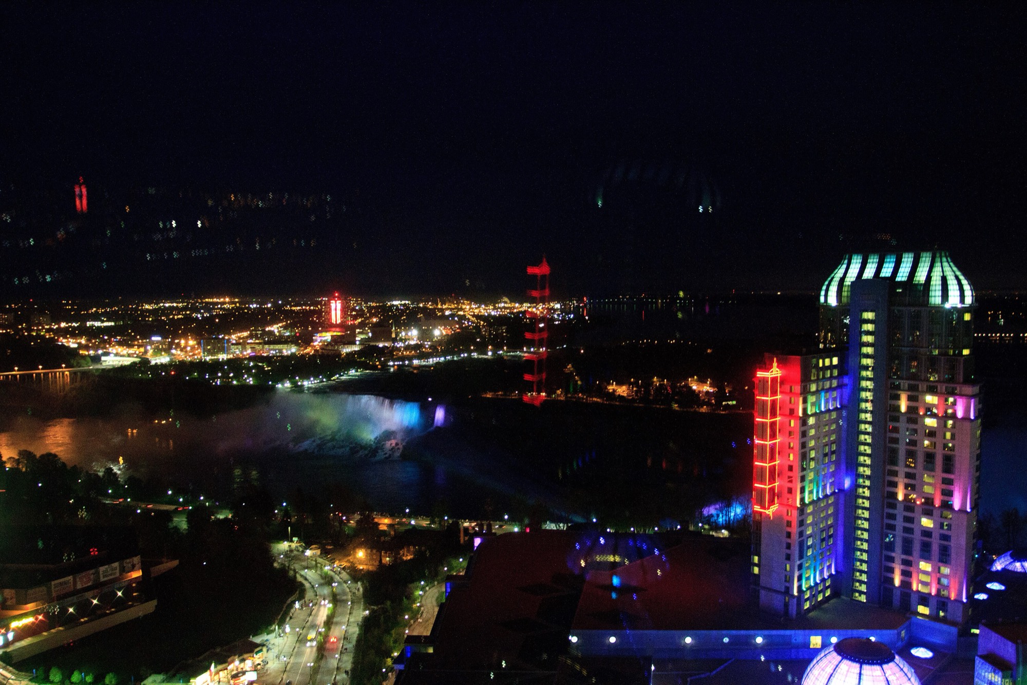 Fallsview Casino Resort lit up at night beside the American Falls, Niagara Falls